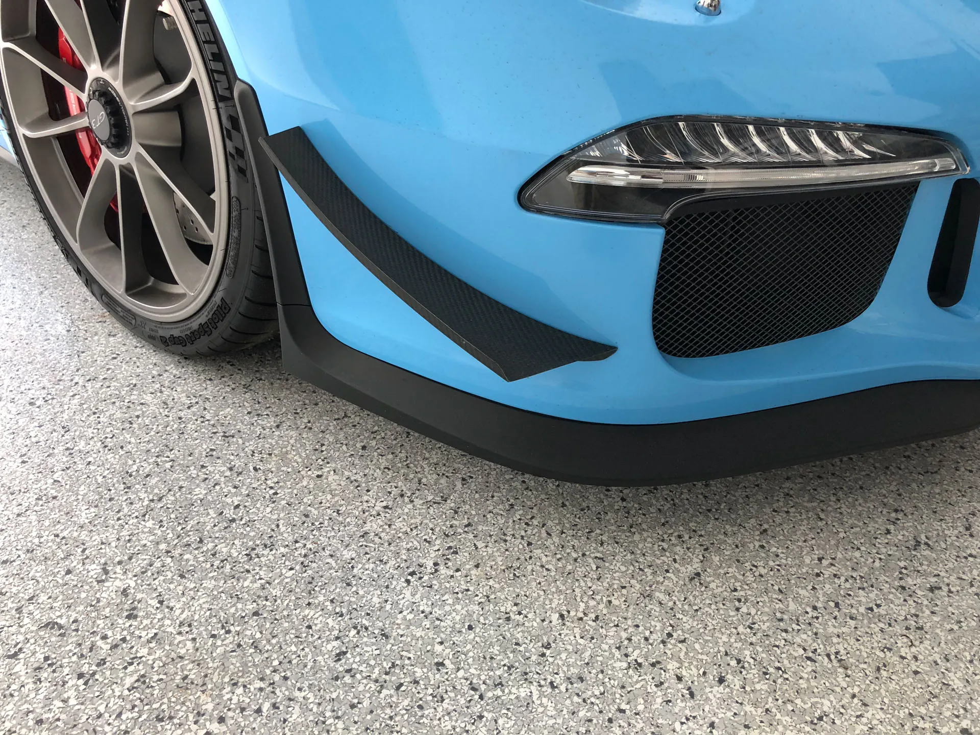 Sports car parked on a flake epoxy garage floor by Tough Floors